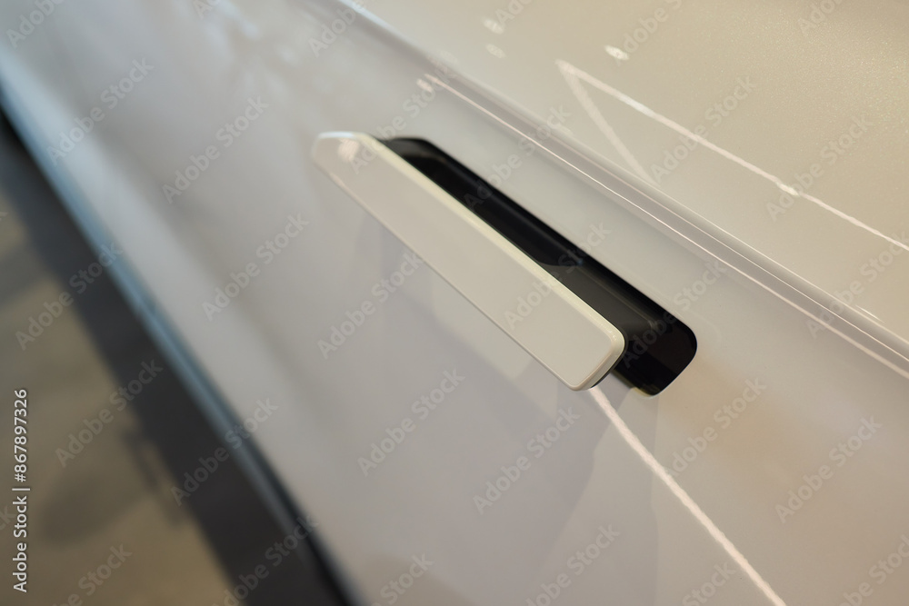 Closeup of a modern car door handle with stylish metallic finish and contemporary design Closeup of a modern car door handle with stylish metallic finish and contemporary design