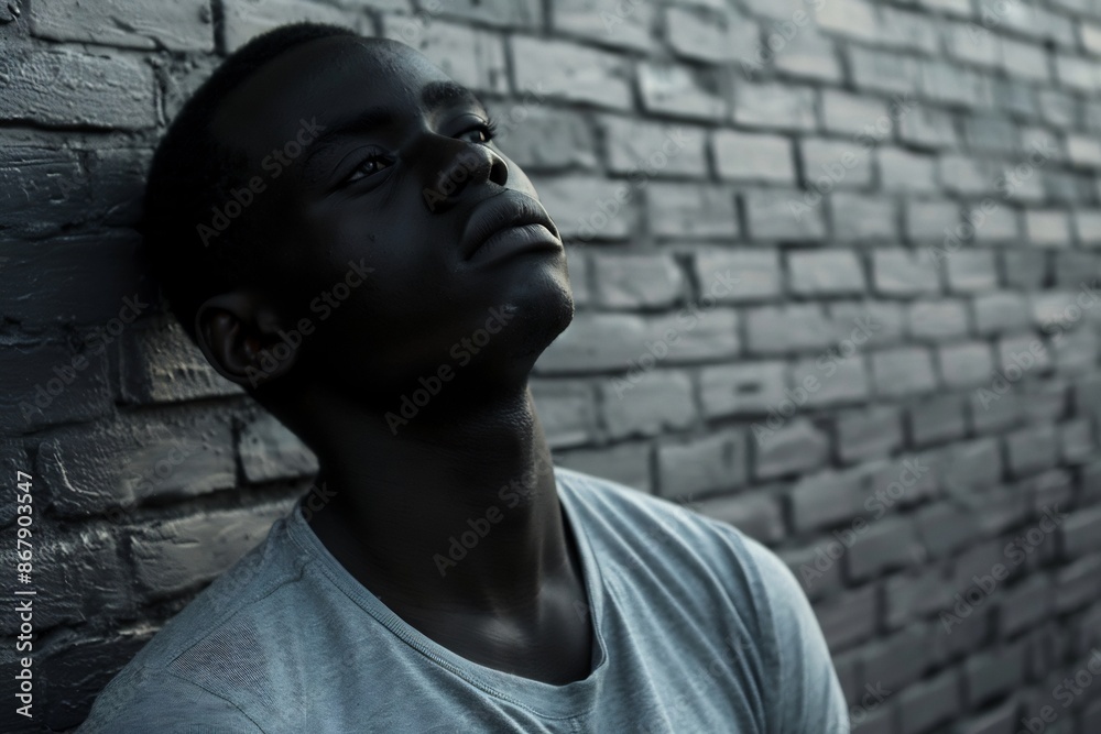 Thoughtful Young Black Man Looking Up Brick Wall Thoughtful Young Black Man Looking Up Brick Wall