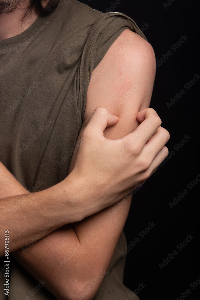Man scratching his shoulder with his hand. Skin disease. Irritation, allergy. Man scratching his shoulder with his hand. Skin disease. Irritation, allergy.