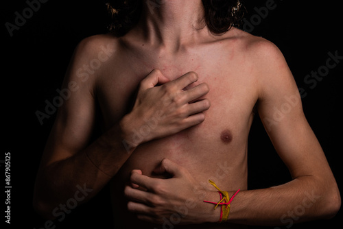 Man, shirtless, scratching his chest with his hand. Skin disease. Irritation, allergy. photo