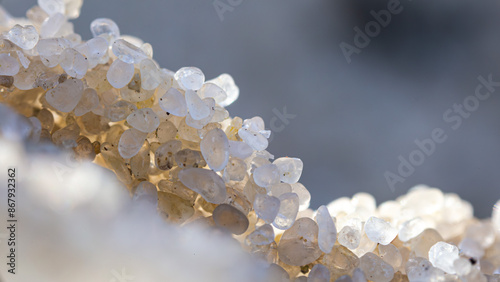 Microphotography, sand grains, close-up, texture, natural pattern, macro lens, microscopy, sunlight, close-up detail, sandy texture, beach grains.