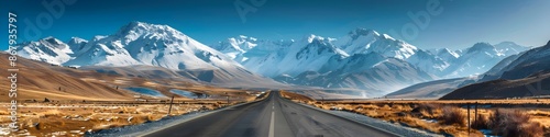 Mountain landscape and asphalt highway under a clear blue sky