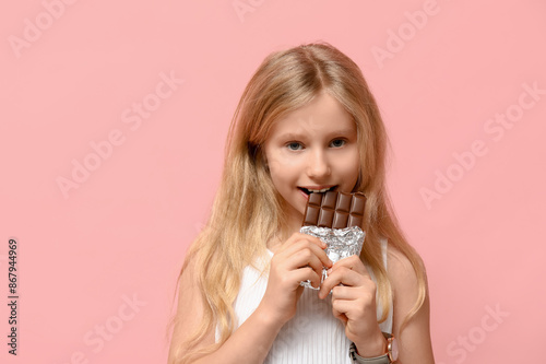 Cute little girl eating swe...