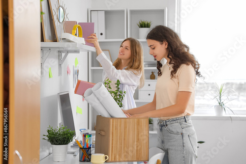 Tableau sur toile Female students unpacking things in dorm room on moving day