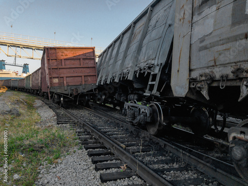 A railway carriage derailed during daylight hours. The wreck of railway wagons. The railway car as a result of the accident came off the rails. Traffic accident on the railway.