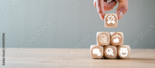 Tableau sur toile Wooden blocks with icons symbolizing the International Organization for Standardization concept, emphasizing quality, standards, and certification