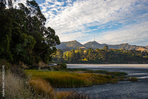 panorama of allandale reserve, governors bay and banks peninsula at sunset; new zealand south island, canterbury, little bay near christchurch photo