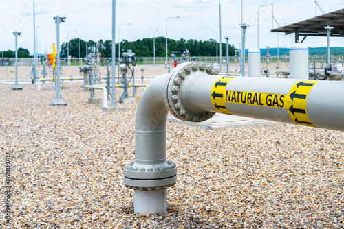 Turn and underground transition of high pressure pipe indicating natural gas and flow direction