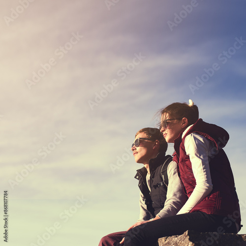 Space, view and couple on mountain peak for travel, adventure or hiking journey in outdoor mockup. Sky, relax or people on rock together for holiday vacation, love or trekking to explore on cliff