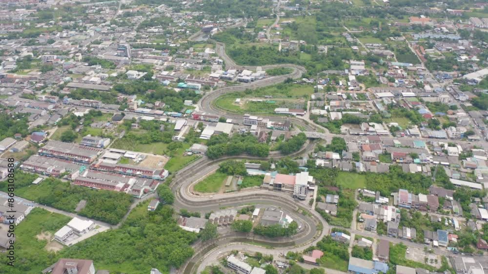 Aerial view of cars driving on curved, zigzag curve road or street on mountain hill with green natural forest trees in rural city town of Songkhla, Thailand. Transportation. Aerial view of cars driving on curved, zigzag curve road or street on mountain hill with green natural forest trees in rural city town of Songkhla, Thailand. Transportation.