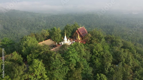 Peaceful mountain temple landscape featuring a majestic Buddha image and lush greenery, ideal for spiritual and travel content.