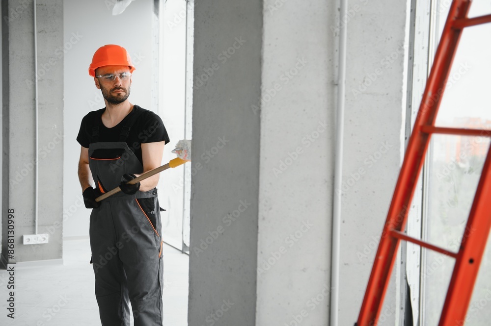 Male workers doing interior renovation in apartment.