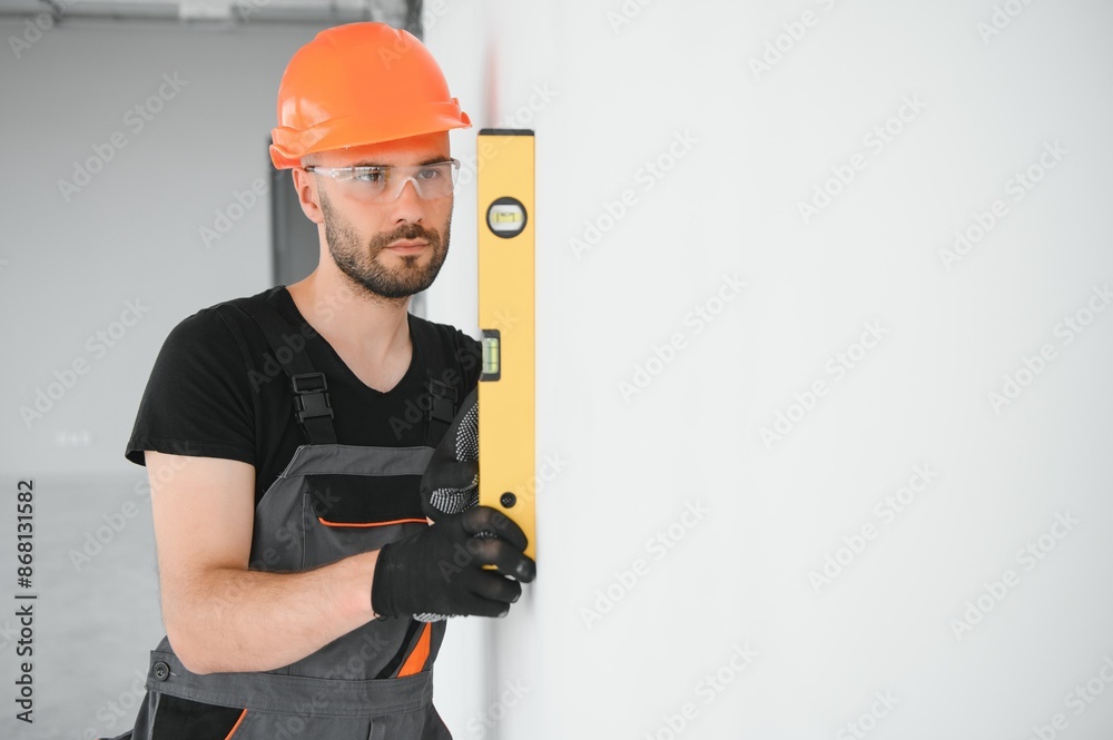 Construction Worker in uniform with spirit level Construction Worker in uniform with spirit level