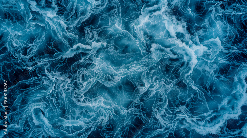 The image is of a body of water with a blue and white swirl pattern. The water appears to be moving and has a sense of motion The image is of a body of water with a blue and white swirl pattern. The water appears to be moving and has a sense of motion
