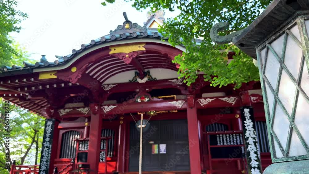 Traditional Japanese temple with ornate red architecture and decorative lantern Traditional Japanese temple with ornate red architecture and decorative lantern