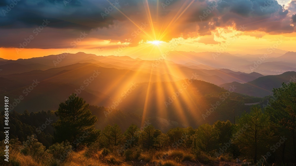 Majestic sunrise with sun rays over a mountain range Majestic sunrise with sun rays over a mountain range