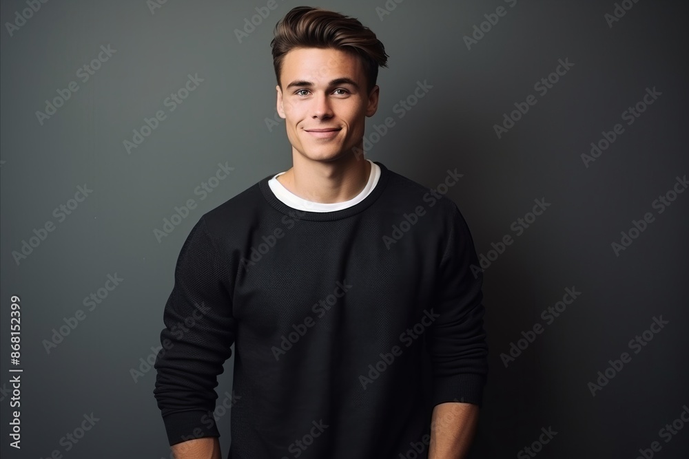 Portrait of a handsome young man in a black sweater. Studio shot. Portrait of a handsome young man in a black sweater. Studio shot.