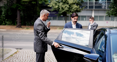 Konstfotografi Corporate Bodyguards assure a safe exit for businessman in luxury vehicle