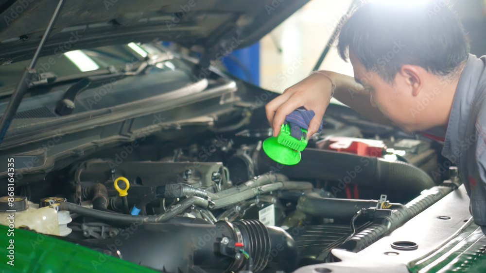 A man is working on a car engine A man is working on a car engine