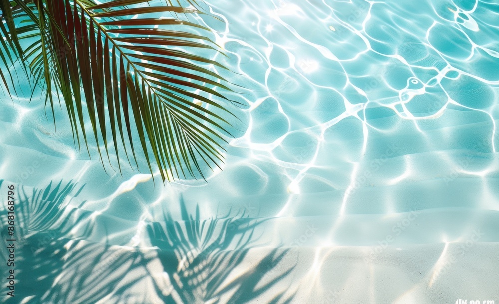Close-up of palm fronds casting shadows on turquoise water near a sandy beach, creating a tranquil tropical atmosphere. Close-up of palm fronds casting shadows on turquoise water near a sandy beach, creating a tranquil tropical atmosphere.
