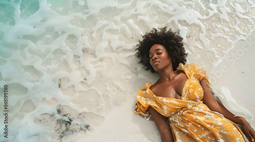 black-skined woman lying on a white sand of caribic beach photo