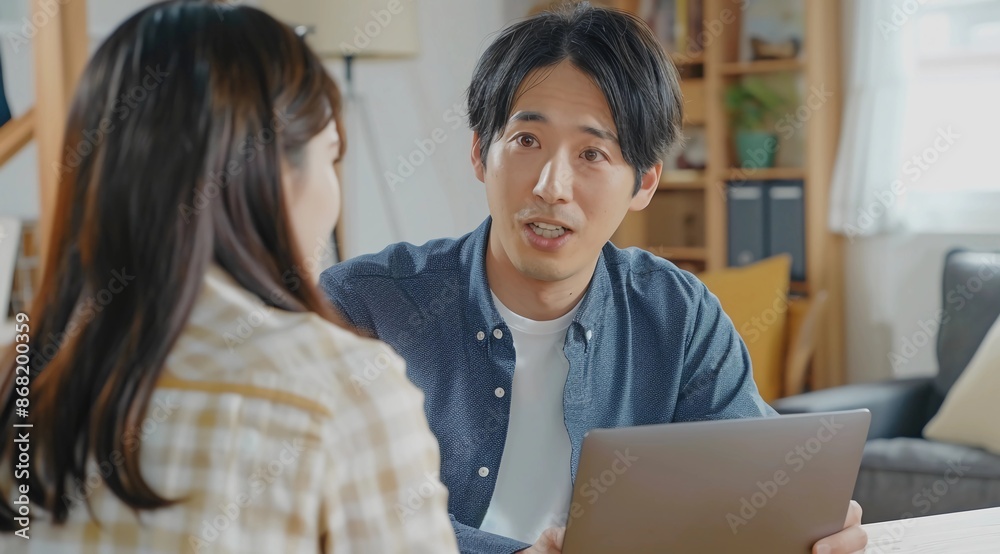 Asian Agent in Suit Explaining Japanese Economy in Bright Office Asian Agent in Suit Explaining Japanese Economy in Bright Office