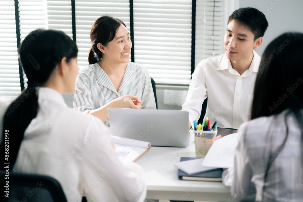 Asian Man and woman co-worker consult about work or team meeting at work with serious emotion. Asian Man and woman co-worker consult about work or team meeting at work with serious emotion.