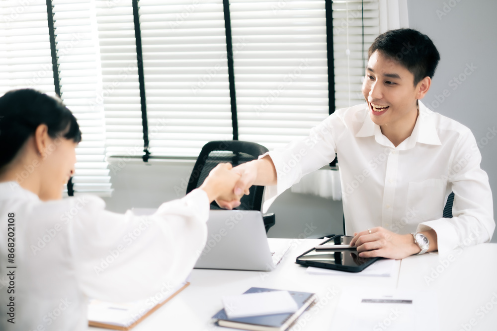 Asian Man and woman co-worker consult about work or team meeting at work with sucessfulness. Check hand shot. Asian Man and woman co-worker consult about work or team meeting at work with sucessfulness. Check hand shot.