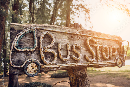 A wooden sign bus stop made with rope letters photo