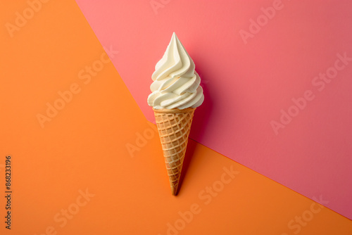 Photo of a single ice cream cone on an orange and pink background, minimal concept, flat lay view from above in studio lighting, pastel colors
