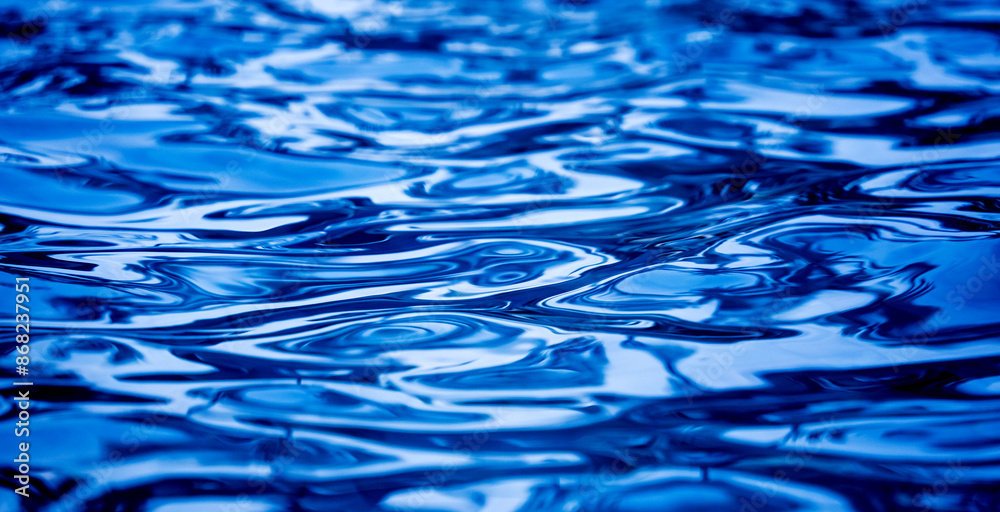 A image of blue ocean waves featuring a water surface in detail A image of blue ocean waves featuring a water surface in detail