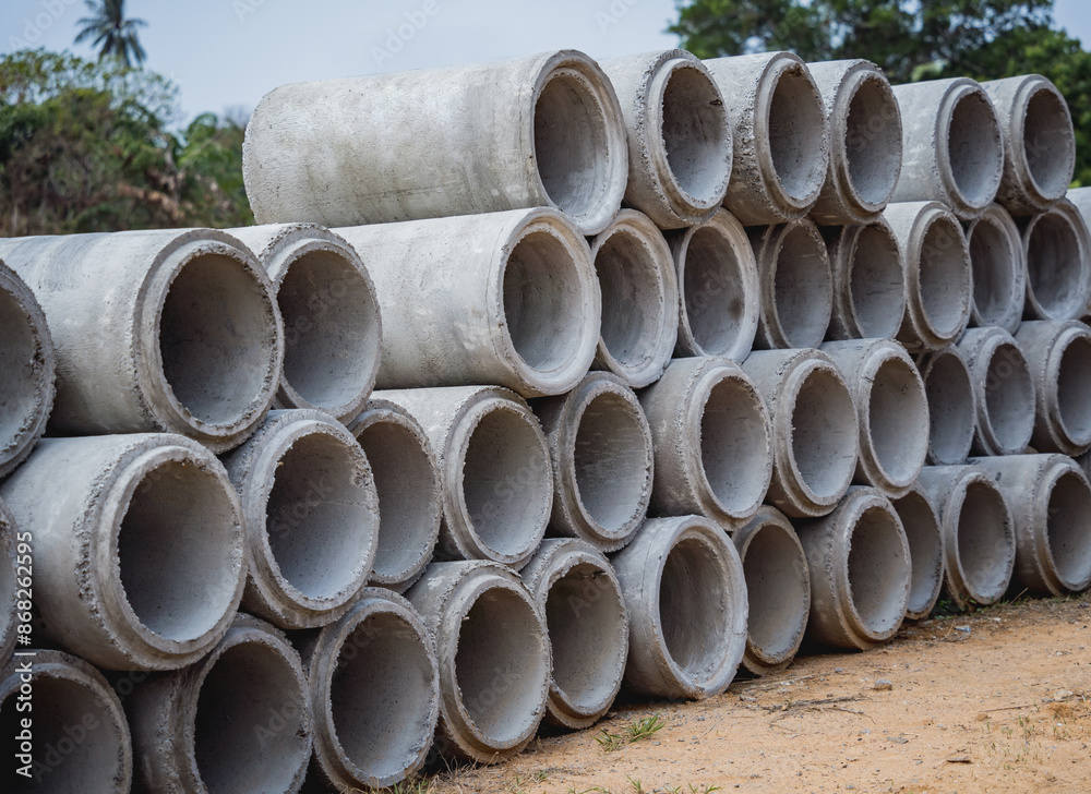 A stack of concrete ring pipes piled and creating a symmetrical arrangement A stack of concrete ring pipes piled and creating a symmetrical arrangement