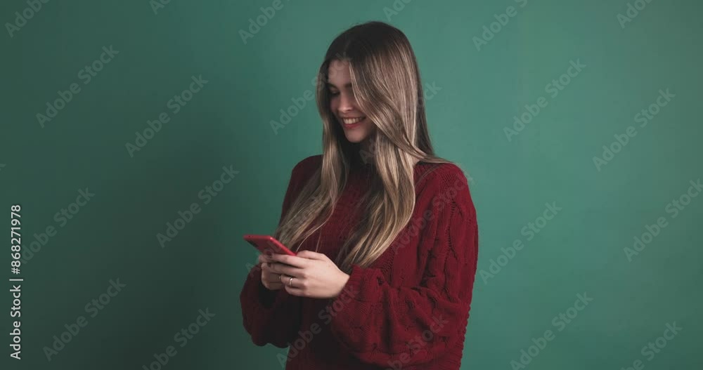 Young woman writing a message on a mobile phone Young woman writing a message on a mobile phone