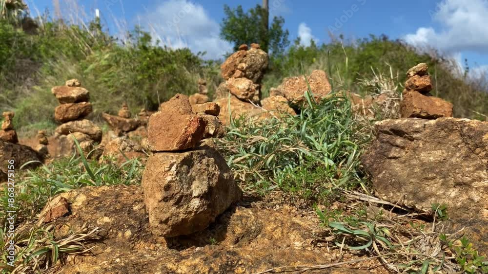 Closeup shot pile of brown stones tower stack rock at mountain outdoor sunny day against blue sky windy day Closeup shot pile of brown stones tower stack rock at mountain outdoor sunny day against blue sky windy day