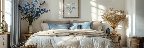 Cozy Elegant Minimalist Bedroom with Blue Accents and Framed Art Above Bed