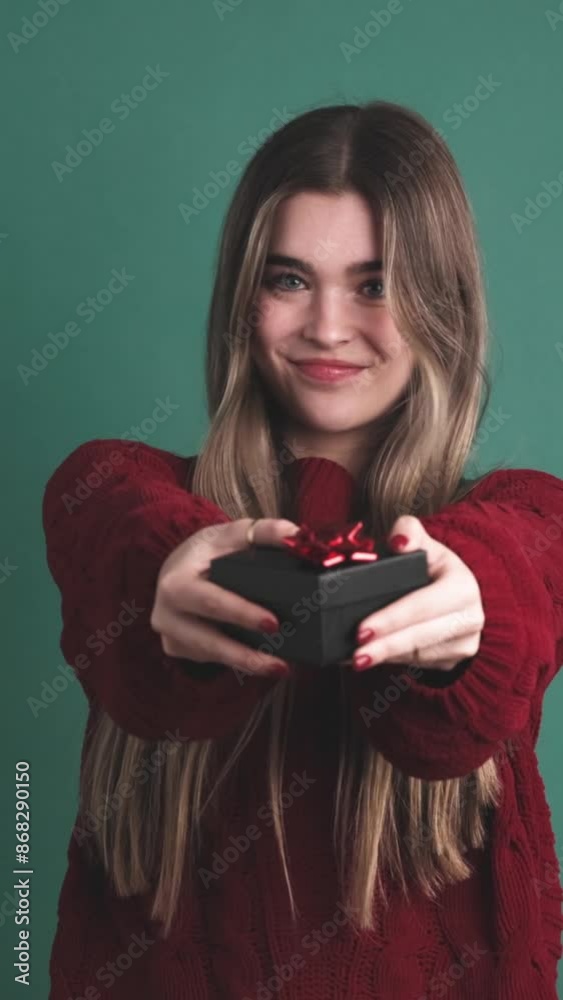 Beauty young woman giving a gift to the camera Beauty young woman giving a gift to the camera