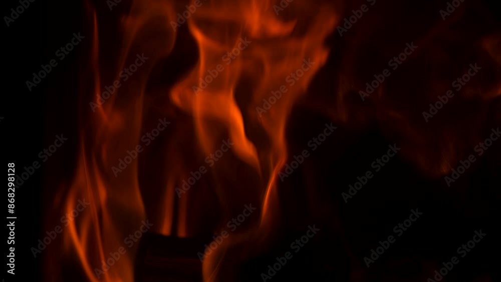 Fire flames with flying sparks background. Firestorm texture, shot of flying fire sparks in the air. Sparks from bonfire over dark night backdrop