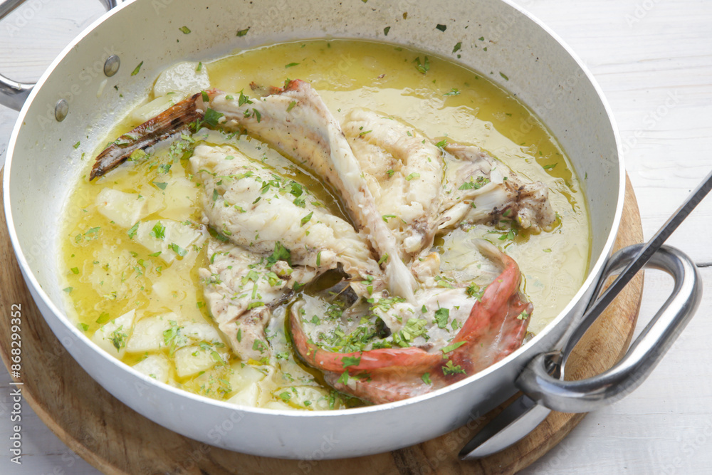 Scorpion Fish (Skorpina) steamed in a lemon sauce with potatoes Scorpion Fish (Skorpina) steamed in a lemon sauce with potatoes
