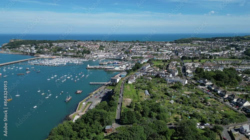Brixham, Torbay, South Devon, England: DRONE VIEWS: The town of Brixham, the suburb of Furzeham and Brixham harbour. Brixham is both a fishing port and a popular English holiday destination. Brixham, Torbay, South Devon, England: DRONE VIEWS: The town of Brixham, the suburb of Furzeham and Brixham harbour. Brixham is both a fishing port and a popular English holiday destination.