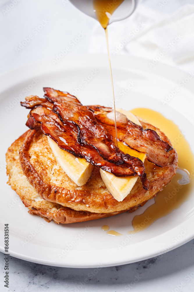 French toast with bacon, banana and maple syrup.