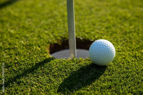 Closeup Golf ball on green grass on course