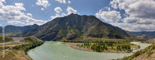 Fototapeta Naklejka Na Ścianę i Meble -  green fast river in mountains under blue sky with clouds