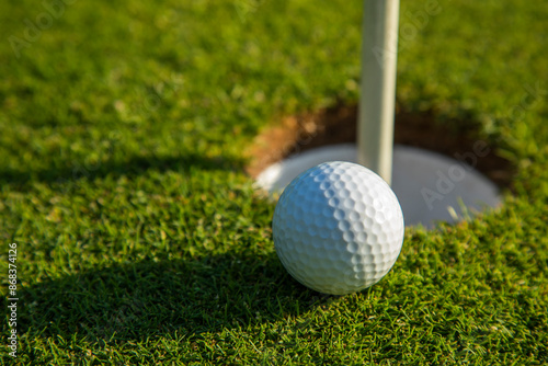 Closeup Golf ball on green grass on course