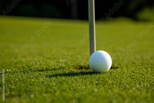 Closeup Golf ball on green grass on course