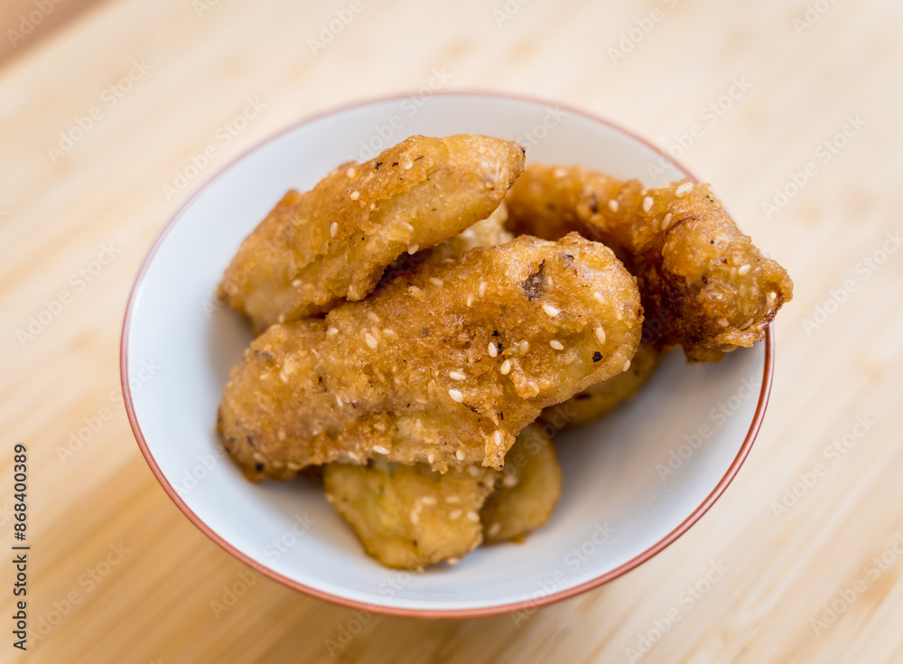 Crispy fried bananas in the small white bowl Crispy fried bananas in the small white bowl