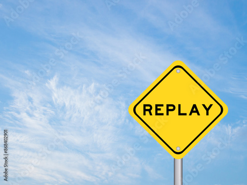 Yellow transportation sign with word replay on blue color sky background