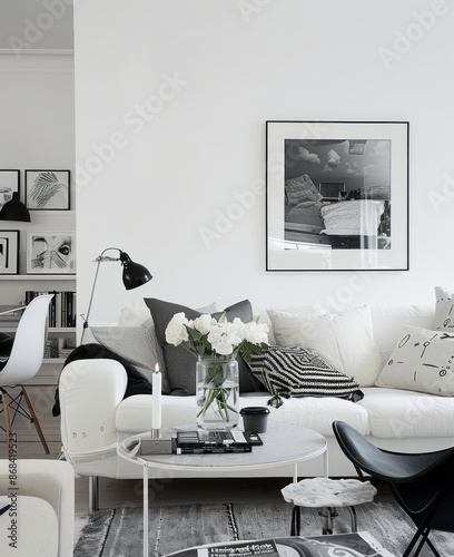 Minimalist interior with white wall, black and white decor, and minimalist art