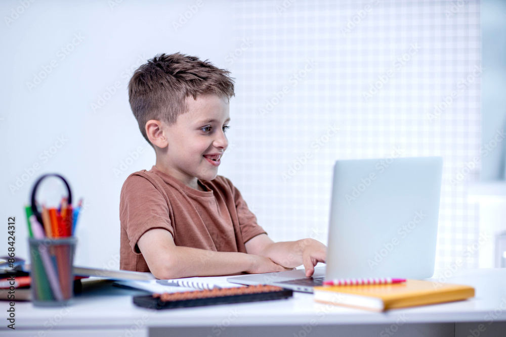 School kid with computer having video conference chat with teacher and class group. Child studying from home. Homeschooling. Modern gadgets for education. Screen time control. Online remote learning. School kid with computer having video conference chat with teacher and class group. Child studying from home. Homeschooling. Modern gadgets for education. Screen time control. Online remote learning.