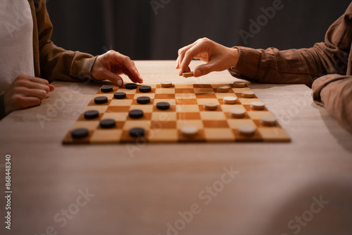 Two Friends Playing Checkers at Home, Enjoying Leisure Time, Cozy Atmosphere