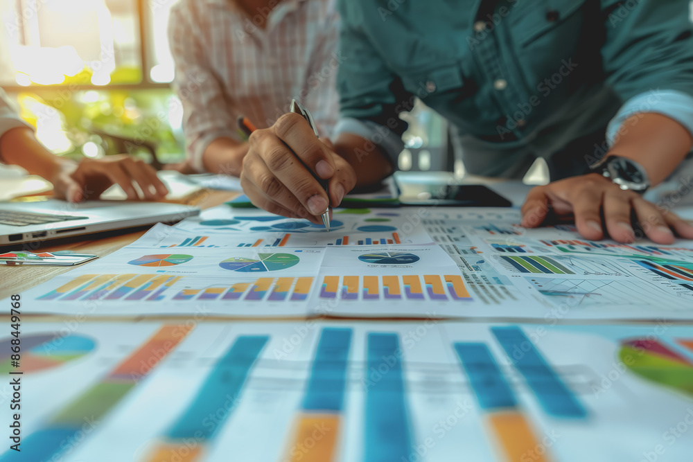 Fototapeta premium Business team having a meeting to analyze data graph charts for a marketing plan in the office.